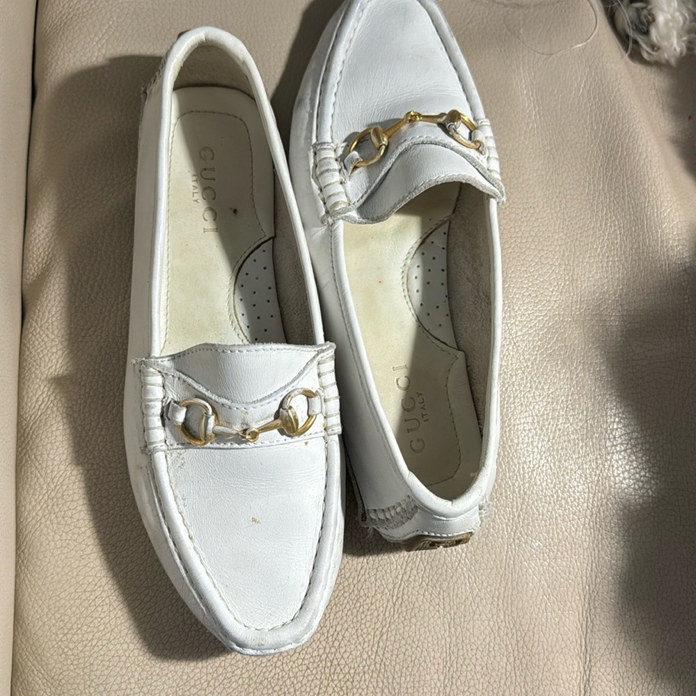 Woman’s white Gucci Driving shoe.